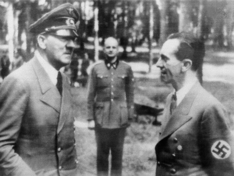 In this official Nazi photo obtained by The Associated Press via neutral Swedish photo agency Pressens Bild, German caption describes a meeting of Adolf Hitler with Dr. Joseph Goebbels, right, at Der Fuhrer's headquarters after a recent assassination attempt, July 27, 1944. Man at center is unidentified. (Nazi Government/Buro Laux/Pressens Bild via AP)