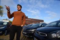 Ameen Sultani speaks as he shows some of the older, cheaper vehicles that have been popular with customers eager to avoid public transport during the coronavirus disease (COVID-19) pandemic, in Hayes