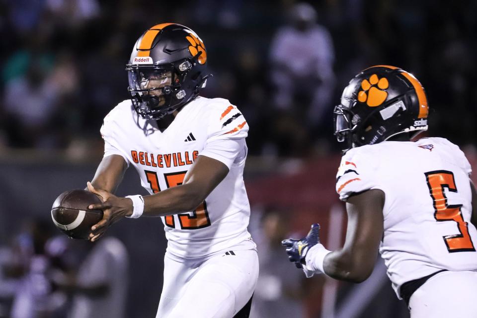 Belleville quarterback Bryce Underwood (19) passes the ball to running back Colbey Reed (5) against River Rouge during the second half of Prep Kickoff Classic at Wayne State University's Tom Adams Field in Detroi on Friday, August 25, 2023.