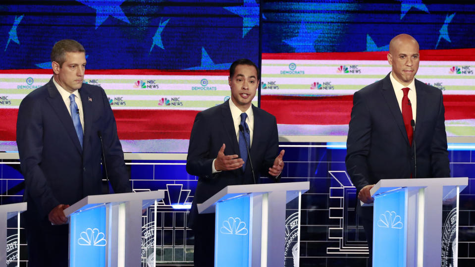 Democratic presidential candidate former Housing Secretary Julian Castro, center, speaks at the Democratic primary debate hosted by NBC News at the Adrienne Arsht Center for the Performing Arts, Wednesday, June 26, 2019, in Miami, as Rep. Tim Ryan, D-Ohio, and Sen. Cory Booker, D-N.J., listen. (AP Photo/Wilfredo Lee)