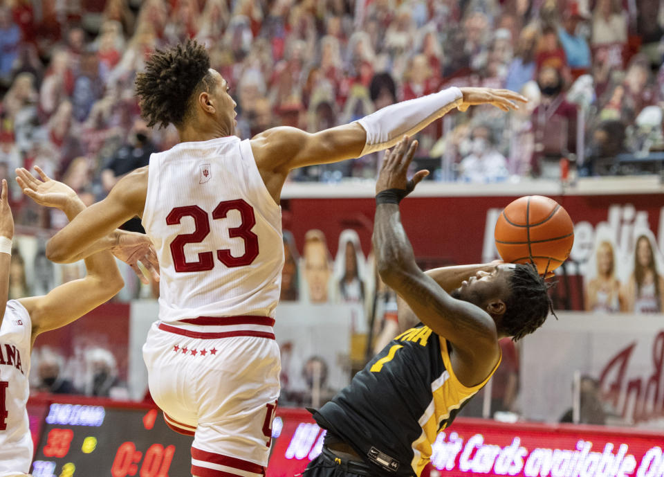 Indiana forward Trayce Jackson-Davis (23) blocks a shot by Iowa guard Joe Toussaint (1) during the first half of an NCAA college basketball game, Sunday, Feb. 7, 2021, in Bloomington, Ind. (AP Photo/Doug McSchooler)