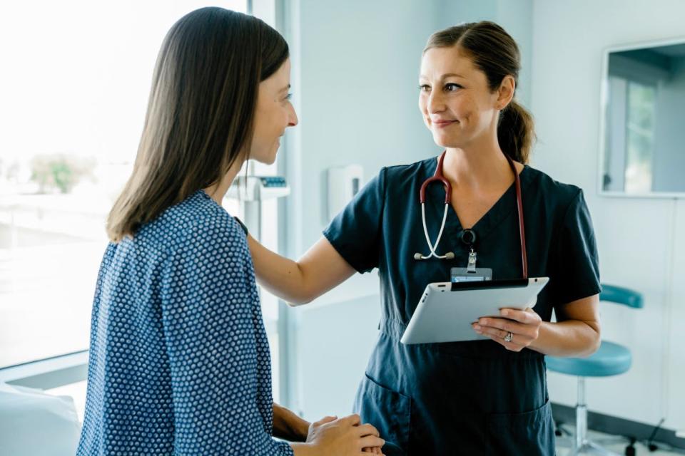 A doctor reassures a patient