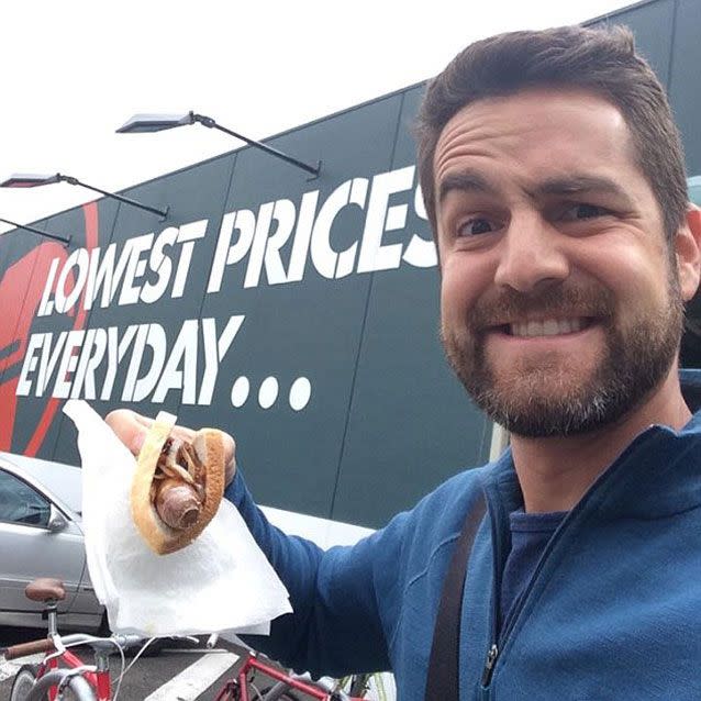 Comedian Ivan Aristeguieta embraces the Aussie tradition of the Bunnings sausage sizzle. Picture: Facebook/Ivan Aristeguieta