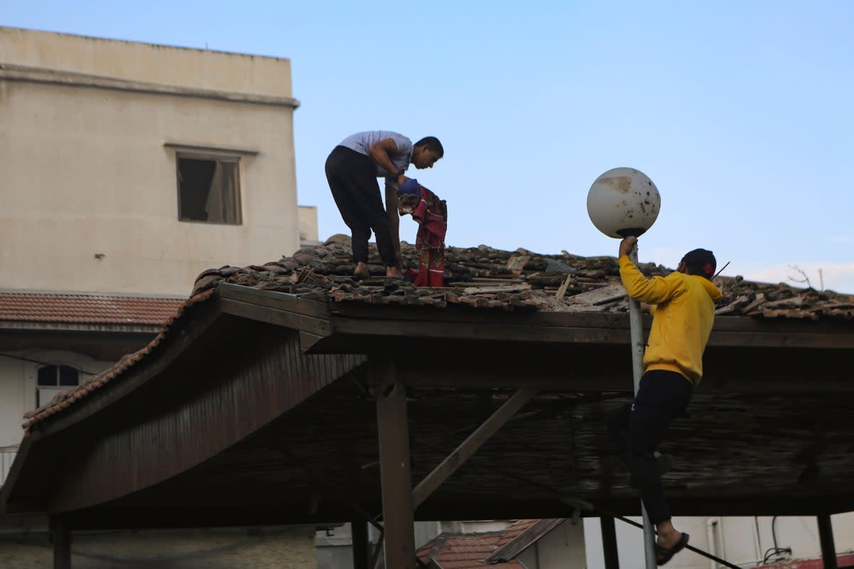 Palestinians inspect the damage at al Ahli hospital, in Gaza City, on Wednesday (Abed Khaled/AP) (AP)