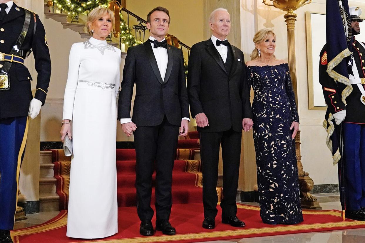 US First Lady Jill Biden, from right, US President Joe Biden, Emmanuel Macron, France's president, and wife Brigitte Macron at the Grand Staircase of the White House ahead of a state dinner in Washington, DC, US, on Thursday, Dec. 1, 2022. Biden said he wouldn't apologize for a new climate and tax law that European leaders say unfairly subsidize American companies, threatening to overshadow a visit by his French counterpart Macron. Photographer: Chris Kleponis/CNP/Bloomberg via Getty Images