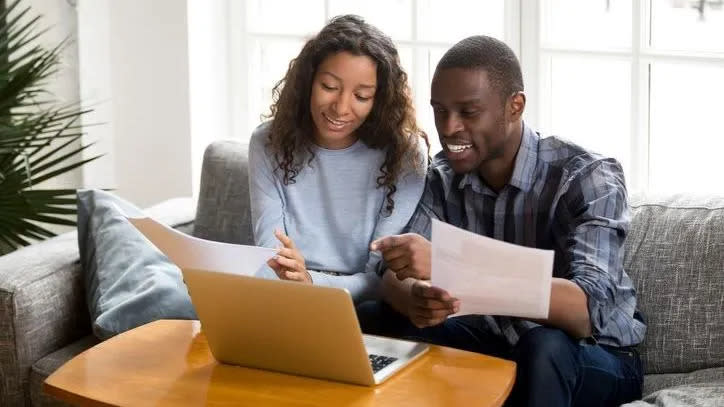 A young couple reviews their finances and sets short-term financial goals. 