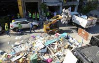 A machine cleans debris at a damaged site following Tuesday's blast in Beirut's port area