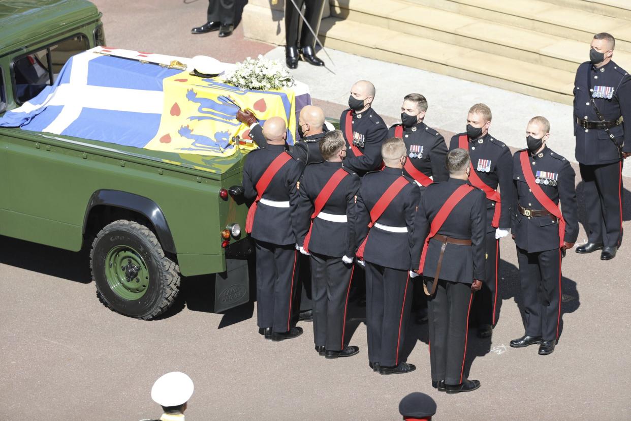 Prince Philip's coffin, borne on the Land Rover he helped to design, is followed by Pall Bearers drawn from regiments, corps, air stations and units with a special relationship to Prince Philip, during the funeral procession in Windsor, England, Saturday, April 17, 2021.