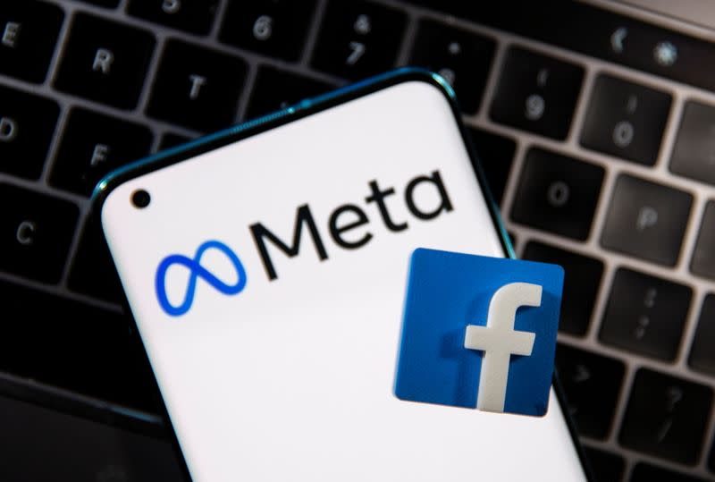 A smartphone with Meta logo and a 3D printed Facebook logo is placed on a laptop keyboard in this illustration