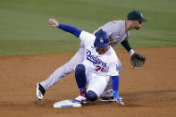 Los Angeles Dodgers' Joc Pederson, bottom, is out at second base next to Oakland Athletics shortstop Marcus Semien on a ground ball from Chris Taylor during the second inning of a baseball game Thursday, Sept. 24, 2020, in Los Angeles. Taylor was safe at first. (AP Photo/Marcio Jose Sanchez)