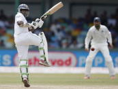Sri Lanka's Rangana Herath hits a boundary during the third day of their third and final test cricket match against India in Colombo, August 30, 2015. REUTERS/Dinuka Liyanawatte