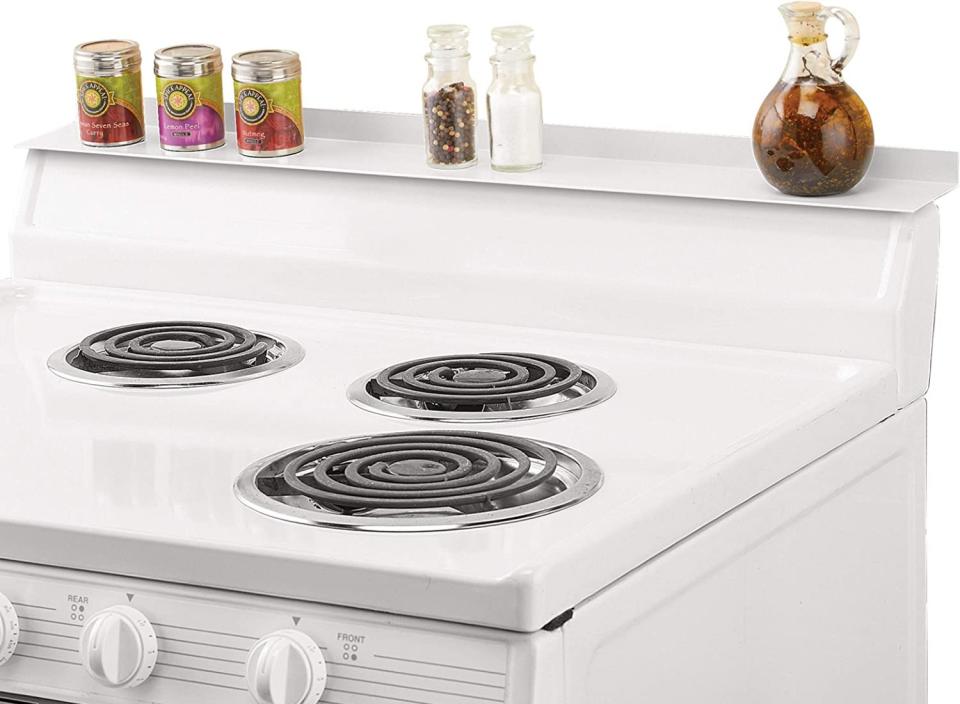 Organize your cooking space with this over-the-stove organizing shelf. (Source: Amazon)