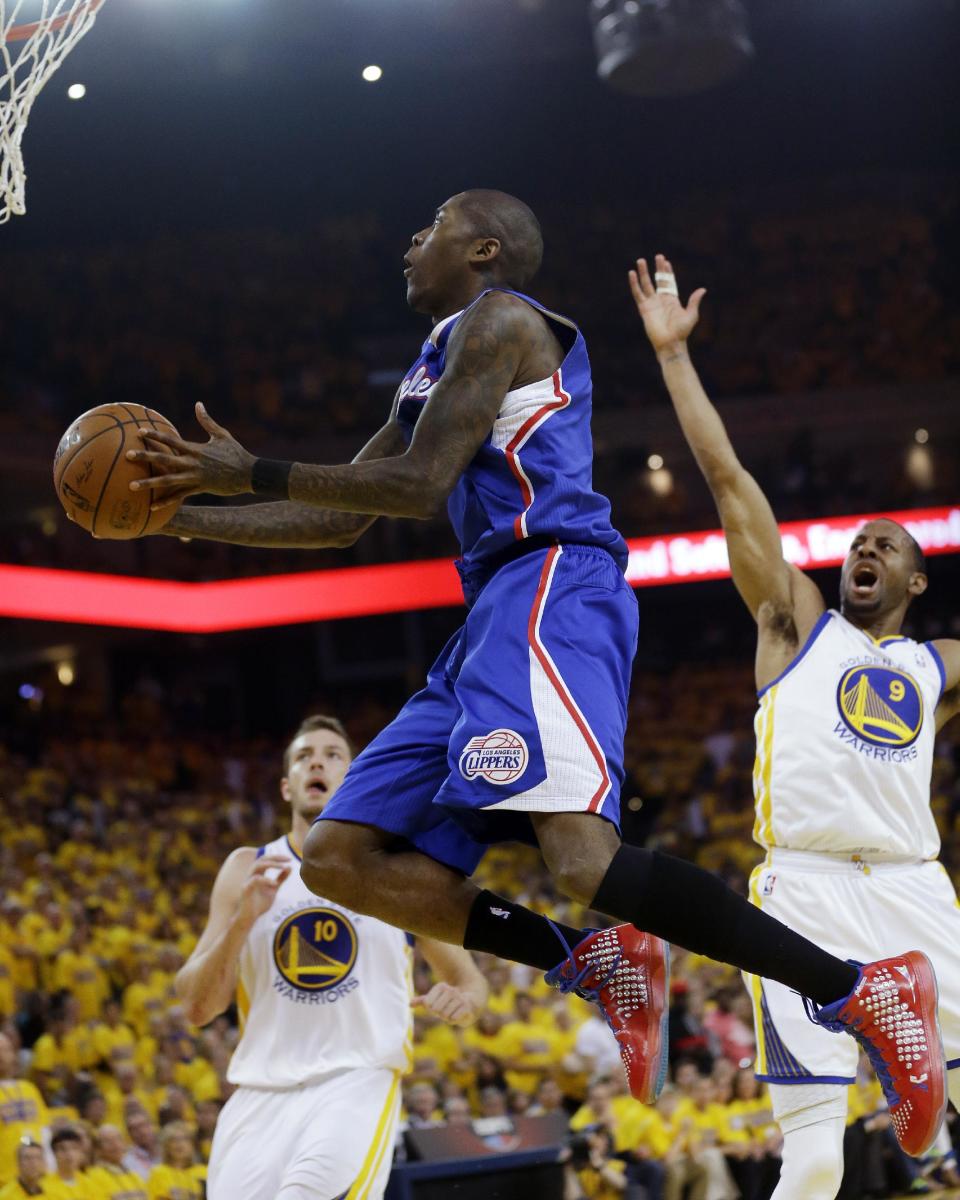 Los Angeles Clippers' Jamal Crawford, center, drives to the basket next to Golden State Warriors' Andre Iguodala (9) and David Lee (10) during the first half in Game 4 of an opening-round NBA basketball playoff series on Sunday, April 27, 2014, in Oakland, Calif. (AP Photo/Marcio Jose Sanchez)