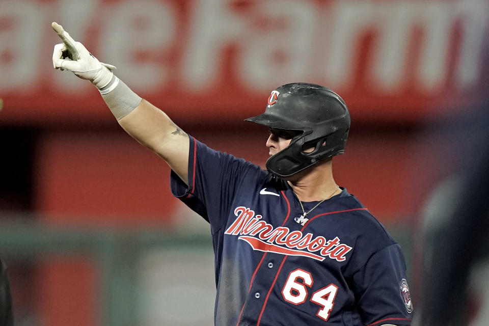 Minnesota Twins' Jose Miranda celebrates at second after hitting a two-run double during the eighth inning of a baseball game against the Kansas City Royals Friday, May 20, 2022, in Kansas City, Mo. (AP Photo/Charlie Riedel)