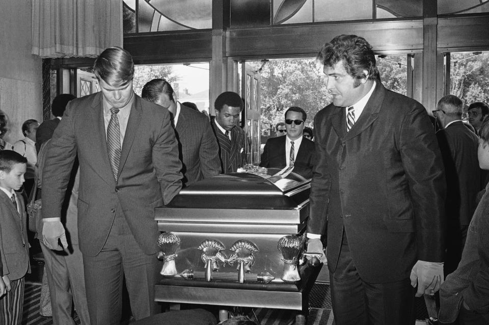 Chicago Bears teammates of Brian Piccolo, who became too ill to play in the middle of last season, carry his coffin into Christ the King Church for funeral services in Chicago, on Friday, June 19, 1970. Left, front to back, are Randy Jackson, Dick Butkus, and Gale Sayers, Picoolo’s roommate. Right, Ed O’Bradovich. (AP Photo)