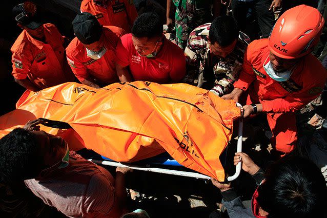 Rescue workers pull victims from destroyed buildings in Indonesia's Aceh Province. Source: Getty