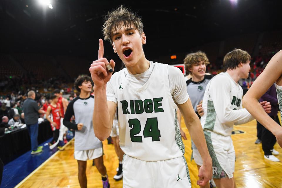 Fossil Ridge boys basketball player Colin Hayes (24) celebrates after the SaberCats won a 6A Final 4 playoff game against Regis 66-62 at the Denver Coliseum on Friday, March 10, 2023, in Denver, Colo.