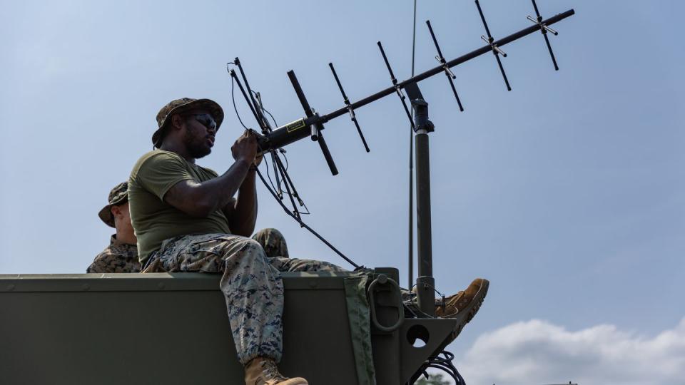 U.S. Marine Corps Cpl. Brandon Meyer sets up a satellite communication antenna as part as a combat-readiness evaluation during Balikatan at the Subic Bay International Airport in the Philippines on April 10, 2023. (Cpl. Kyle Chan/U.S. Marine Corps)