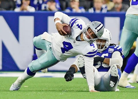 Dallas Cowboys quarterback Dak Prescott (4) is brought down by Indianapolis Colts defensive end Denico Autry (96) in the second half at Lucas Oil Stadium - Credit: Thomas J. Russo/USA TODAY