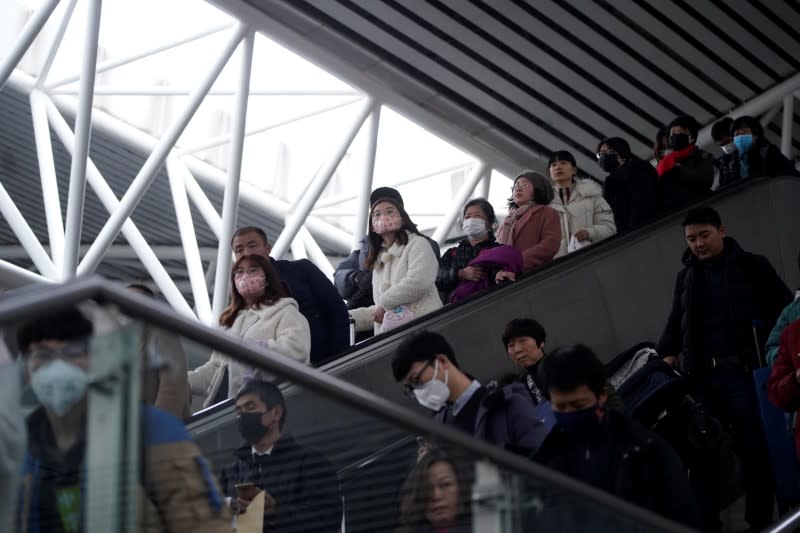 Passengers wearing masks are seen at Shanghai railway station in Shanghai