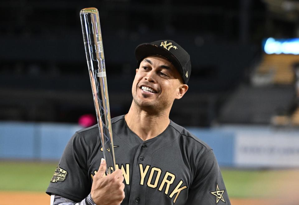 Giancarlo Stanton smiles with the All-Star MVP award.