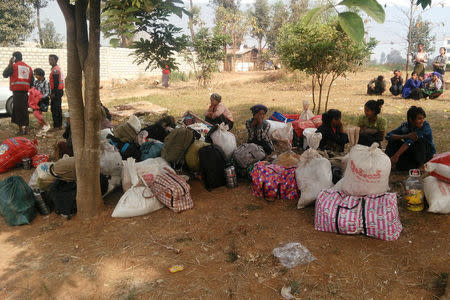 Displaced people are seen with their belongings after fighters of the Myanmar National Democratic Alliance Army (MNDAA) launched an attack on March 6 on police, military, and government sites in Laukkai, Myanmar March 8, 2017. REUTERS/Stringer