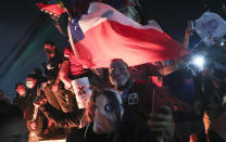 People gather at Plaza Italia on the day Chileans voted in a referendum to decide whether the country should replace its 40-year-old constitution, written during the dictatorship of Gen. Augusto Pinochet, in Santiago, Chile, Sunday, Oct. 25, 2020. (AP Photo/Esteban Felix)