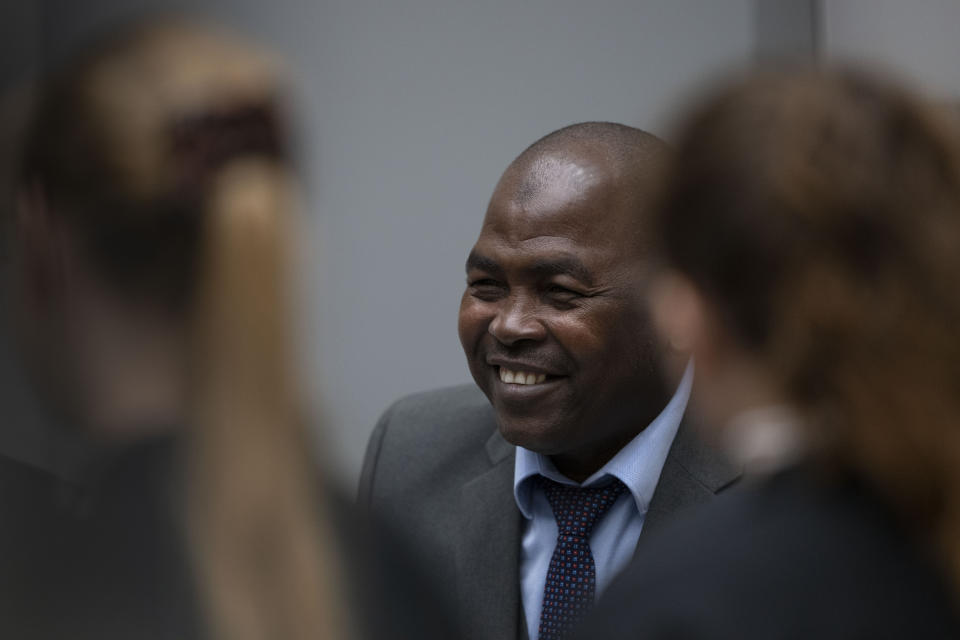 Mahamat Said Abdel Kani talks to his defence lawyers in the court room of the International Criminal Court in The Hague, Netherlands, Monday, Sept. 26, 2022. The trial of an alleged commander in a mainly Muslim rebel group from Central African Republic opened and charged Said with crimes against humanity and war crimes. (AP Photo/Peter Dejong, Pool)