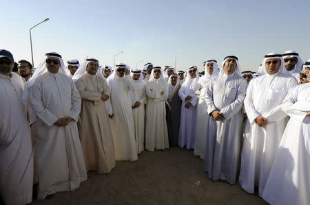 Son of the Emir of Kuwait Sheikh Nasser Sabah al Ahmed al Sabah (C, 5th R) and Speaker of Parliament Marzouk al Ghanim (6th R) and other dignitaries attend the funerals of victims of a bombing at a mosque on Friday, at Al Jafariya cemetery in Suleibikhat, Kuwait June 27, 2015. REUTERS/Stringer