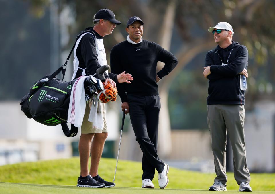 Tiger Woods, center, talks with caddie Lance Bennett, left, and Rob McNamara on the third hole during the Genesis Invitational pro-am golf event at Riviera Country Club, Wednesday, Feb. 14, 2024, in the Pacific Palisades area of Los Angeles. (AP Photo/Ryan Kang)