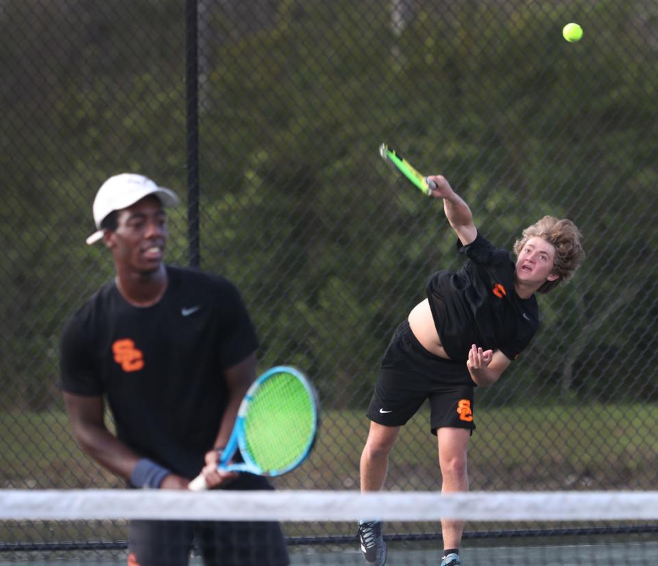 Spruce Creek High's s Zane Ensminger hits. serve in doubles actio with Demario Dawkin, Friday March 8, 2024 during Five Star Conference Tennis Championships.