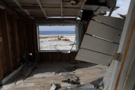 A picturesque view is seen through the window of a destroyed vacation home in the aftermath of Hurricane Michael in Mexico Beach, Fla., Wednesday, Oct. 17, 2018. (AP Photo/Gerald Herbert)