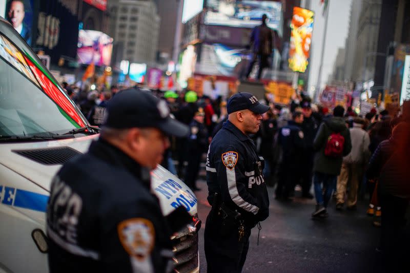 NYPD officers keep an eye on protesters as they take part in an anti-war protest amid increased tensions between the United States and Iran at Times Square in New York