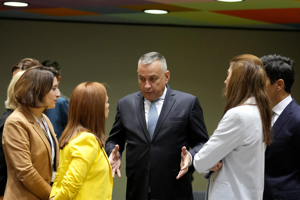 Czech Republic's Minister for Industry and Trade Jozef Sikela, center, speaks with Malta's Energy Minister Miriam Dalli, center left, during a meeting of EU energy ministers in Brussels on Friday, Sept. 30, 2022. European Union energy ministers were set Friday to adopt a package of measures including a windfall levy on profits by fossil fuel companies, but a deal on capping gas prices remained off the table. (AP Photo/Virginia Mayo)