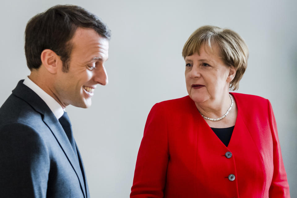 French President Emmanuel Macron, right, speaks with German Chancellor Angela Merkel on the sidelines of an EU summit in Brussels, Thursday, March 21, 2019. British Prime Minister Theresa May is trying to persuade European Union leaders to delay Brexit by up to three months, just eight days before Britain is scheduled to leave the bloc. (Geert Vanden Wijngaert, Pool)