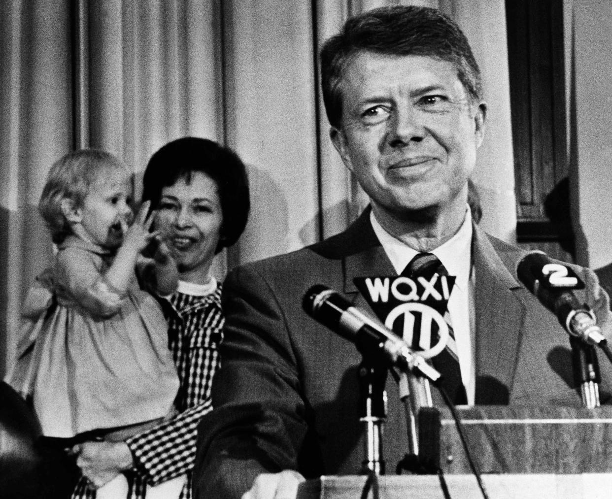 Former State Sen. Jimmy Carter listens to applause at the Georgia State Capitol on April 3, 1970, in Atlanta, after announcing his candidacy for governor. In the background, his wife Rosalyn holds their two-year-old daughter Amy who joined in the applause.