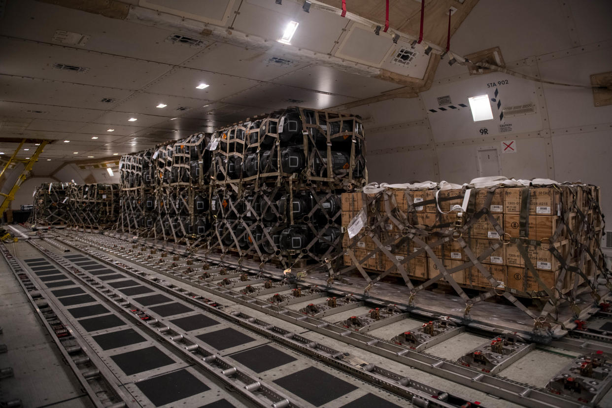 In this image provided by the U.S. Air Force, pallets of ammunition, weapons and other equipment bound for Ukraine are loaded on a plane by the 436th Aerial Port Squadron during a foreign military sales mission at Dover Air Force Base, Del., on Jan. 24, 2022. Since 2014, the United States has committed more than $5.4 billion in total assistance to Ukraine, including security and non-security assistance. (Roland Balik/U.S. Air Force via AP)