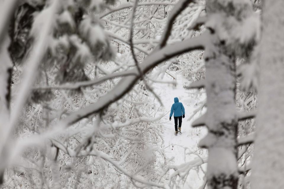 A hiker takes a walk in the Lake Park grounds in Milwaukee, Wisconsin