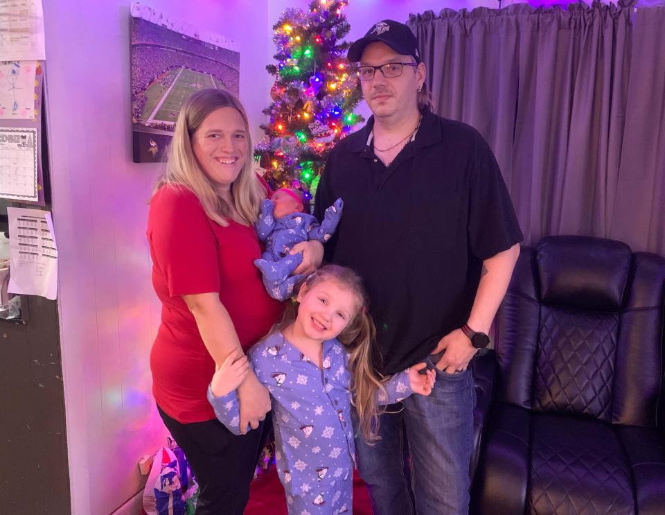 Samantha, Tony, Hadley and Harper Alten all pose together by the Christmas tree in their home a day after Hadley was brought home from her month-long stay in the NICU.