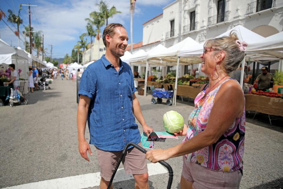 Erin Darling, left, a candidate for L.A. City Council District 11, greets voter Lainie Sugarman.