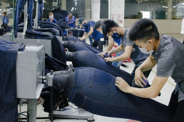 <p>Saitex employees hand-distressing jeans. Photo: Whitney Bauck/Fashionista</p>