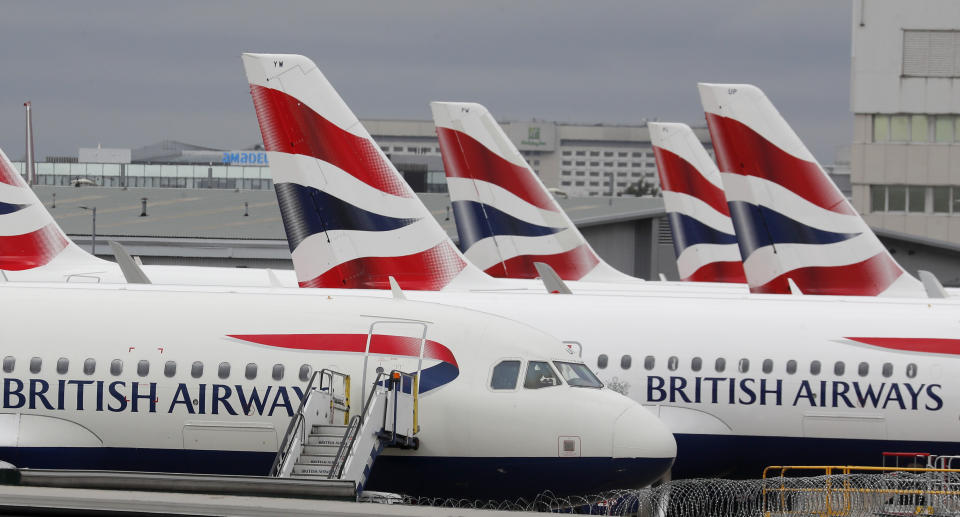 British Airways planes parked at Terminal 5 Heathrow airport in London, Wednesday, March 18, 2020. Britain's Foreign Secretary Dominic Raab has taken the decision to advise British nationals against non-essential travel globally for an initial period of 30 days, and of course subject to ongoing review. For most people, the new coronavirus causes only mild or moderate symptoms, such as fever and cough. For some, especially older adults and people with existing health problems, it can cause more severe illness, including pneumonia. (AP Photo/Frank Augstein)
