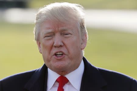 U.S. President Donald Trump speaks to the media as he departs the White House to visit Walter Reed National Military Medical Center in Washington, U.S., December 21, 2017. REUTERS/Jim Bourg