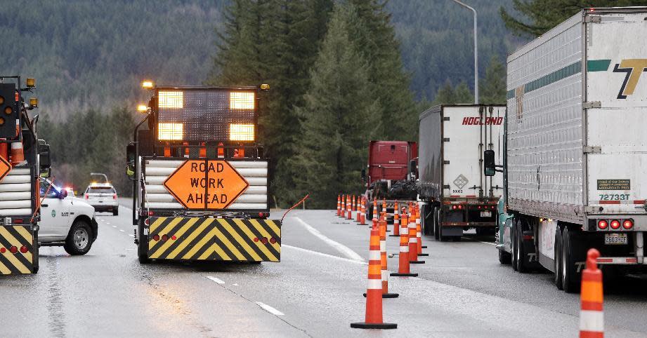 Trucks and other traffic is diverted off of eastbound Interstate 90 before Snoqualmie Pass, Wednesday, Jan. 18, 2017, in North Bend, Wash. An ice storm shut down parts of major highways and interstates Wednesday in Oregon and Washington state and paralyzed the hardest hit towns along the Columbia River Gorge with up to 2 inches of ice coating the ground in some places. In Washington state, I-90, the main highway connecting western and eastern Washington, was to remain closed over Snoqualmie Pass because of hazardous winter conditions. (AP Photo/Elaine Thompson)