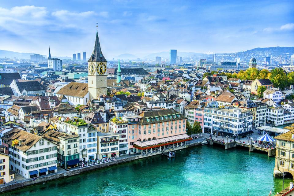 An aerial view of Zurich shows St. Peter’s church tower overlooking the Limmat River.