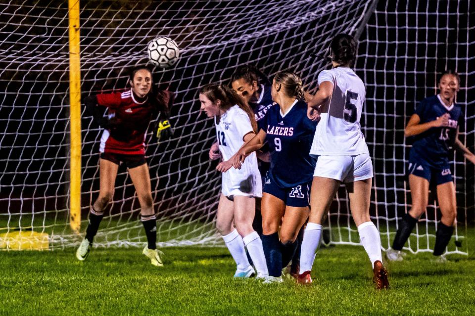 Apponequet goalie Grace Schwartz track the ball.