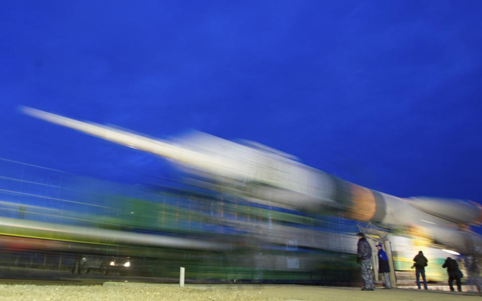 The Soyuz TMA-12M spacecraft is transported from the assembling hangar to its launch pad at the Baikonur cosmodrome