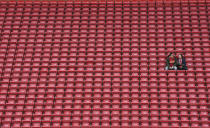 People sit on the tribune as they wait the start of the English Premier League soccer match between Liverpool and Bournemouth at Anfield stadium in Liverpool, England, Saturday, March 7, 2020. (AP Photo/Jon Super)