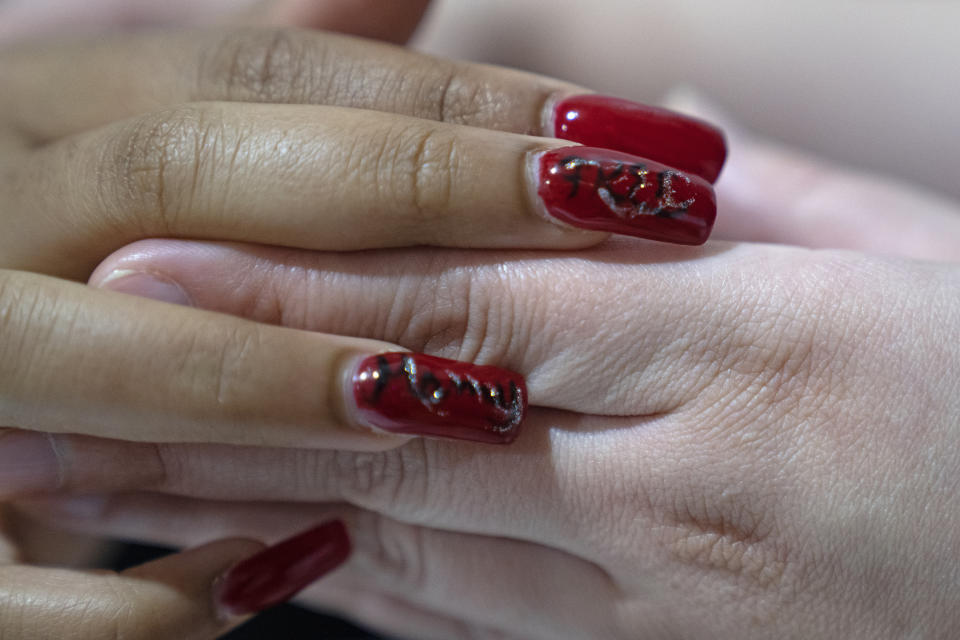 Nevaeh Martinez, 3-year-old, has "free mommy" painted on her fingernails as she and her four younger siblings visit their mother Crystal Martinez at Logan Correctional Center, Saturday, May 20, 2023, in Lincoln, Illinois. Rare programs like the Reunification Ride, a donation-dependent initiative that buses prisoners' family members from Chicago to Illinois' largest women's prison every month so they can spend time with their mothers and grandmothers, are a crucial lifeline for families, prisoners say. (AP Photo/Erin Hooley)