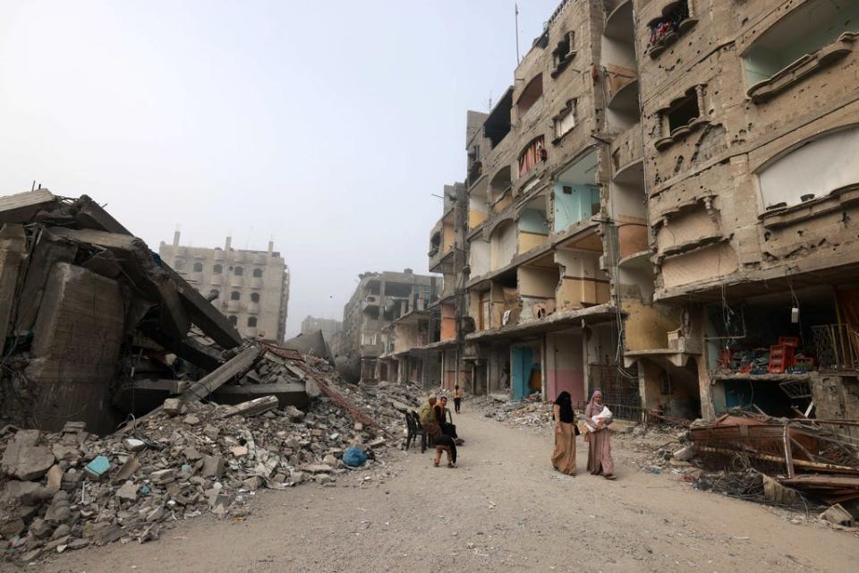 People walk in front of the Al-Faruk mosque, levelled by Israeli bombardment in Rafah in the southern Gaza Strip on Feb. 25, 2024, amid continuing battles between Israel and the Palestinian militant group Hamas.